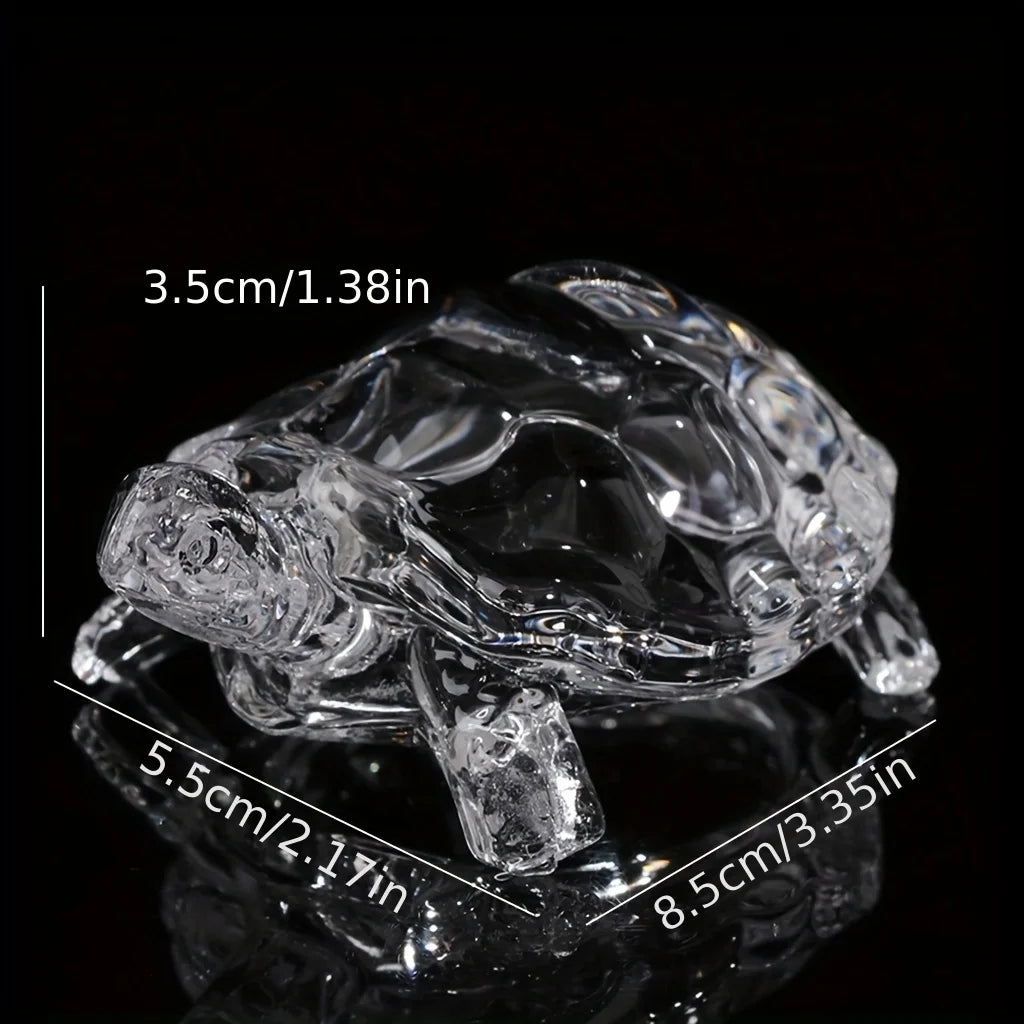 Clear glass miniature tortoise statue with a reflective surface shown from above.