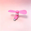 A pink portable USB-C mini fan with soft blades shown against a light pink background.
