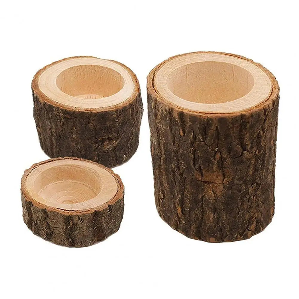 A set of rustic wooden tree stumps used as candle holders.