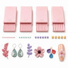 A set of pink precision clay bead rollers with varying diameters and decorative beads.