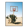 A framed canvas wall art depicting a basketball hoop against a clear blue sky with a palm tree in the foreground.