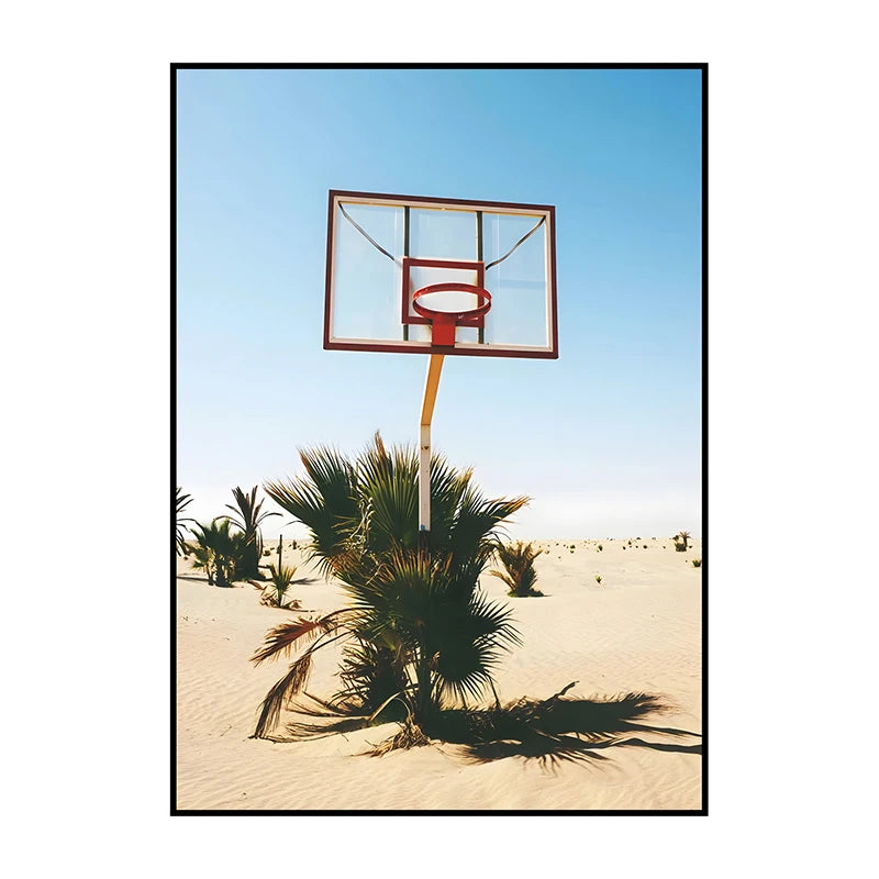 A framed canvas wall art depicting a basketball hoop against a clear blue sky with a palm tree in the foreground.