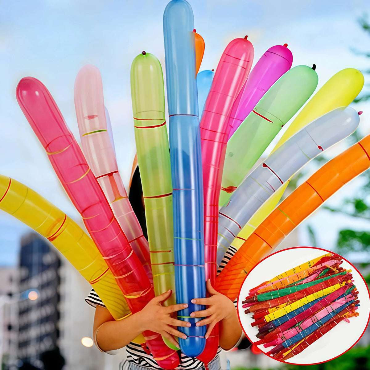 A child holds a colorful rocket balloon strip party decoration featuring pink, green, and blue balloons.