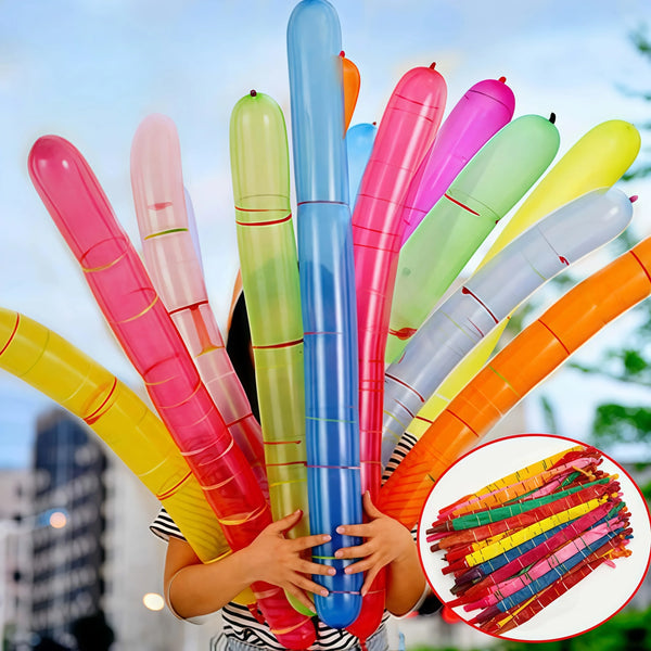 A child holds a colorful rocket balloon strip party decoration featuring pink, green, and blue balloons.