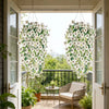 A hanging vine of white flowers and green leaves decorates a porch entryway.