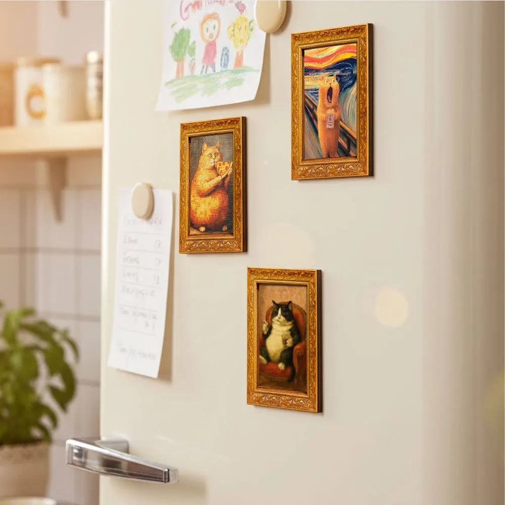 A display of framed magnets featuring cats eating pizza on a white wall.