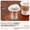 A clear disposable drinking cup with a lid is shown on a wooden surface.