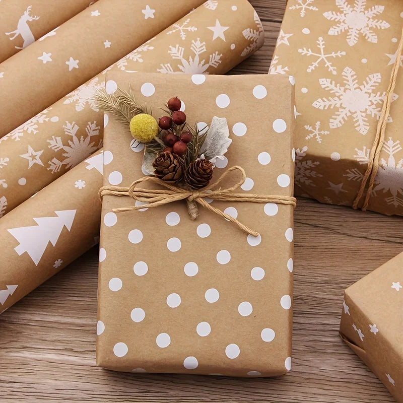 A brown gift box wrapped in patterned paper with white polka dots and decorated with natural greenery.
