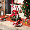 A terracotta semi-sheer cheesecloth table runner set with red accents and festive holiday decorations on a wooden table.