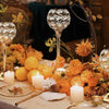 A close-up of a crystal candle holder with a golden finish used as a decorative tealight stand in an autumnal centerpiece arr
