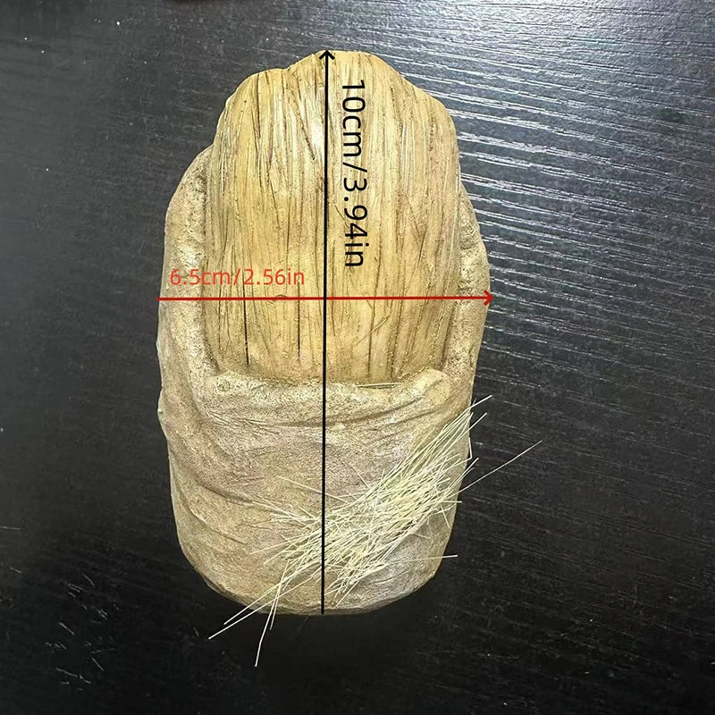 A light brown resin figurine of a Bigfoot toe with measurements marked on the side.