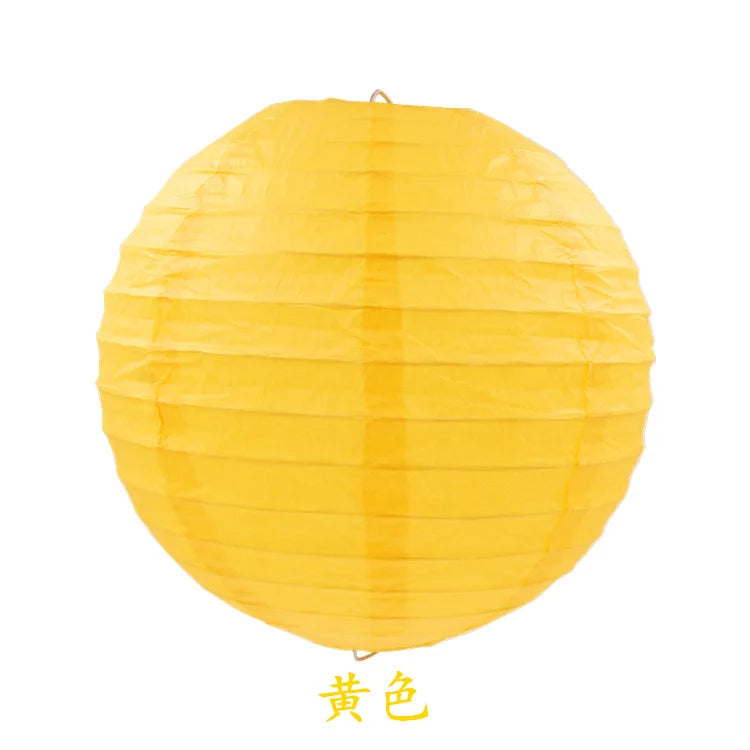 A bright yellow round paper lantern used for parties and weddings.