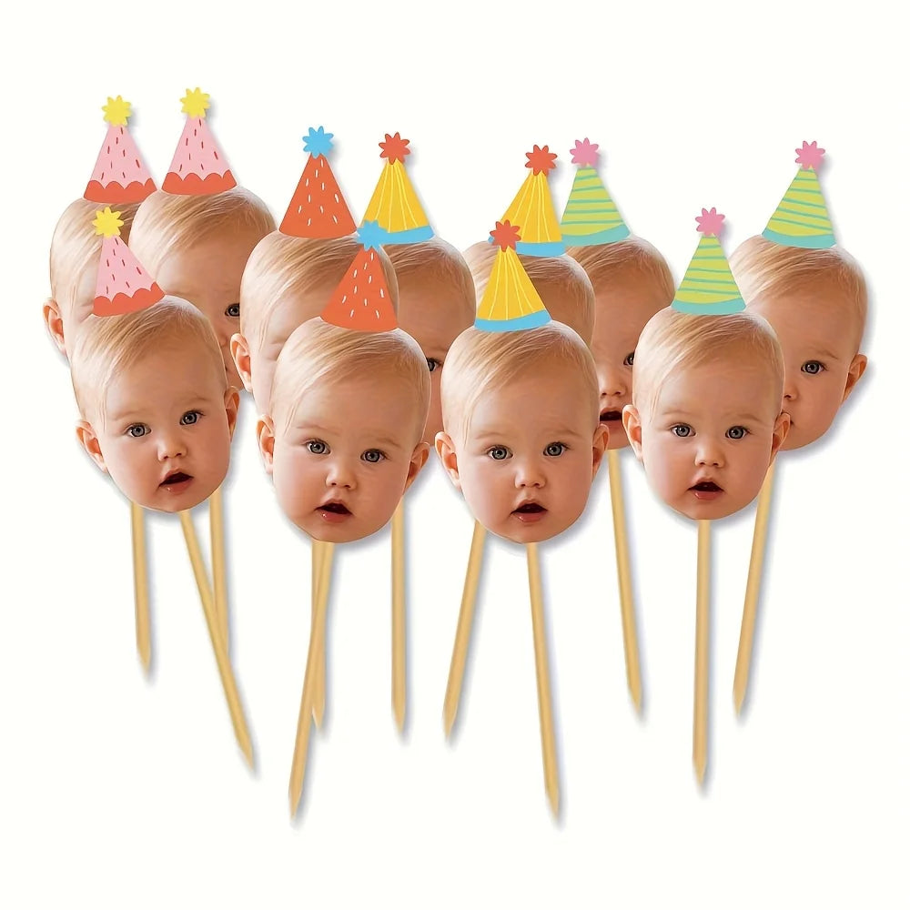 A collection of baby photo cupcake toppers featuring various colored party hats on wooden sticks.