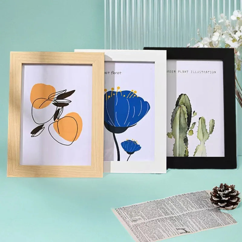 Three wooden photo frames display botanical illustrations on white backgrounds.