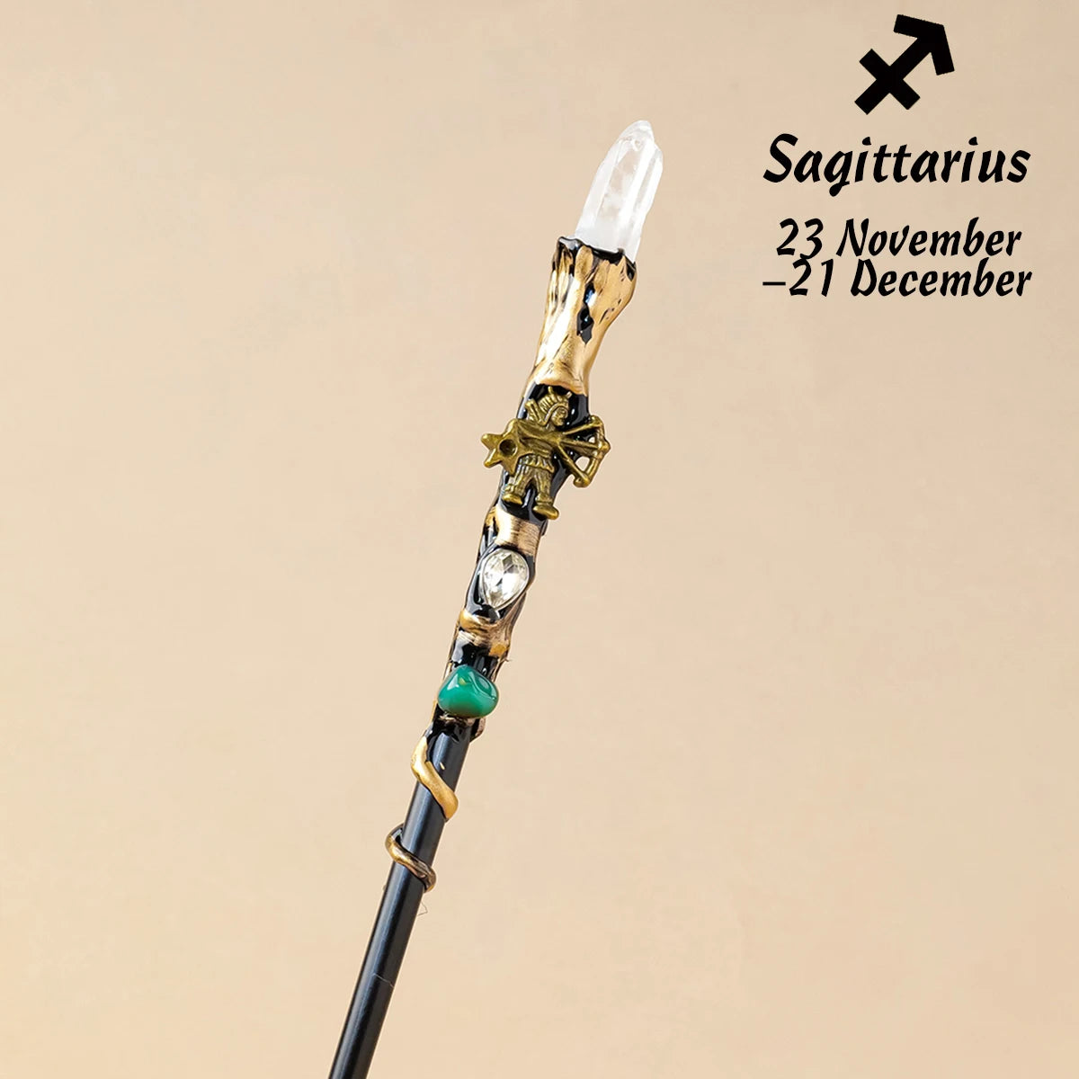 A natural clear quartz zodiac crystal wand with gold accents and a green bead, used for meditation and healing.
