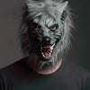 A realistic werewolf full head mask with gray fur and sharp teeth worn by a person.