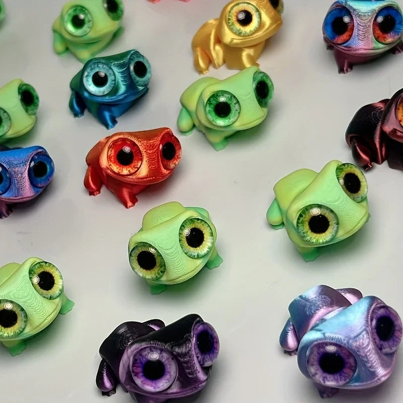 A collection of 3D printed frog car ornaments featuring various colors and color-shifting eyes.