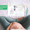 A pregnancy and baby memory journal organizer with various planners, stickers, and a newborn welcome card displayed on a whit