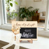 A wooden ultrasound photo frame with a ribbon, featuring text that reads love at first sight.
