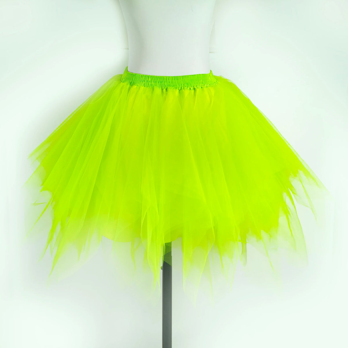 Bright lime green tulle tutu skirt displayed on a mannequin.