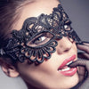 Close-up of a woman wearing a black lace floral eye mask for a masquerade or cosplay.