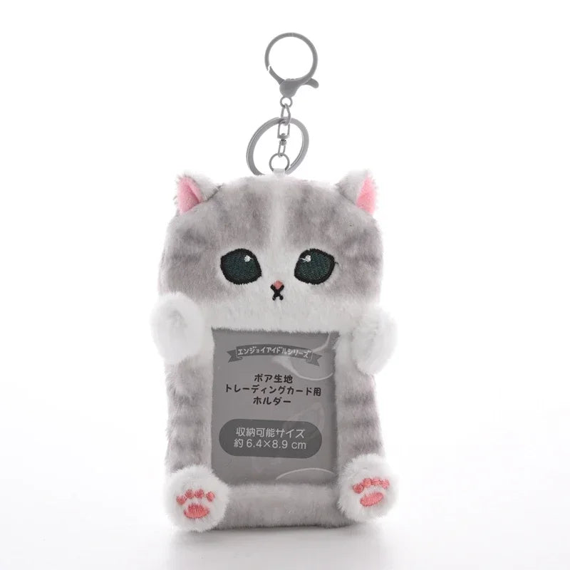 A gray cat keychain featuring a multi-character Kpop photocards holder.