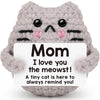 A handmade gray crochet cat doll with black stripes and a card that says I love you the meowst