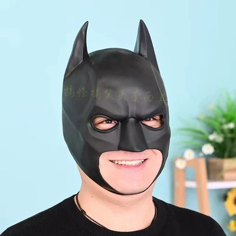 A person is wearing a realistic black cat mask for a Halloween costume.