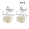 A set of two decorative flower butterfly curtain tiebacks with silver wire and white silk flowers.