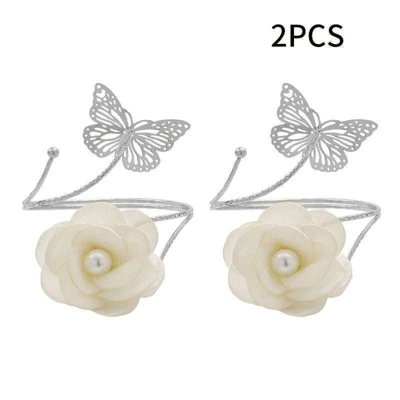 A set of two decorative flower butterfly curtain tiebacks with silver wire and white silk flowers.