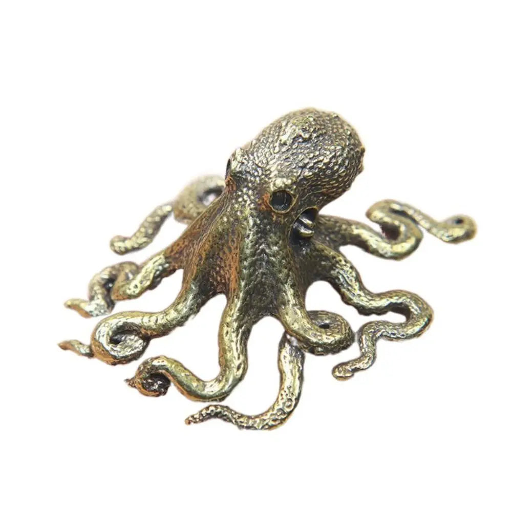 Antique brass octopus desk ornament with textured body and flowing tentacles