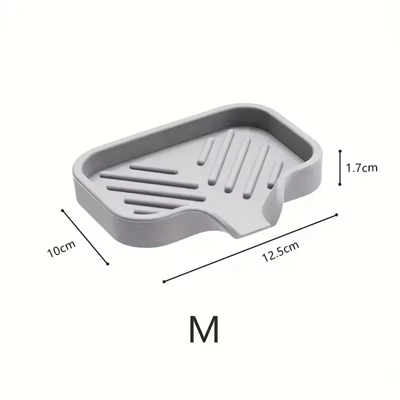 Gray silicone faucet splash guard and drying mat with measurement lines.