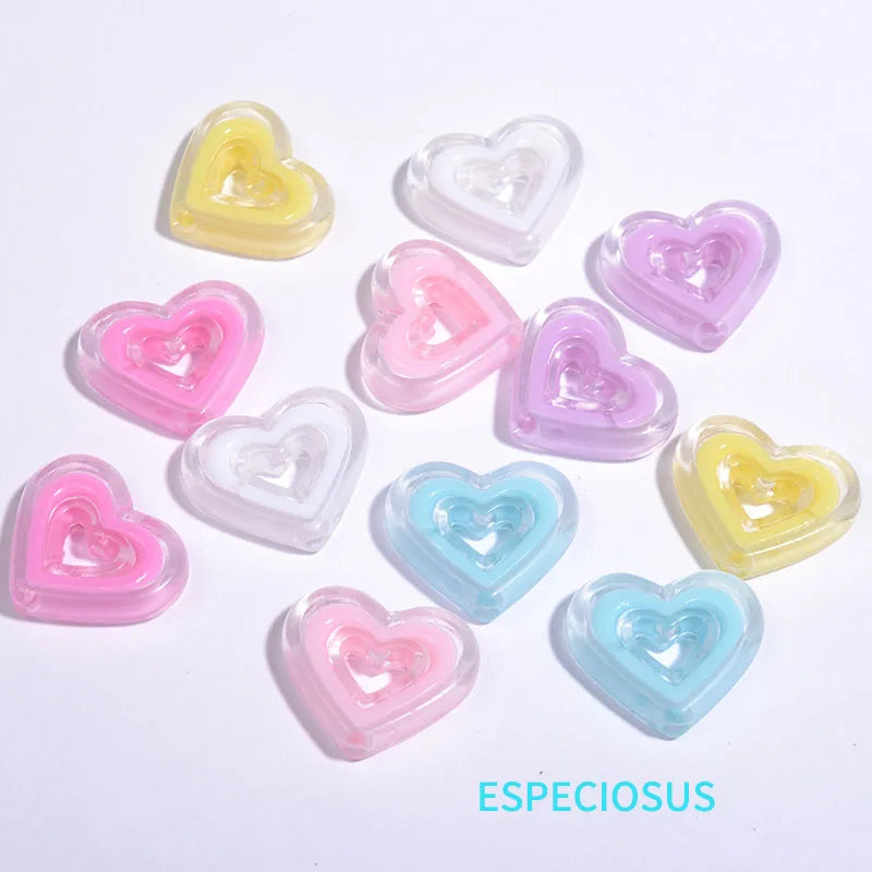 A collection of multi-color heart-shaped acrylic charms in pink, yellow, and purple shades.