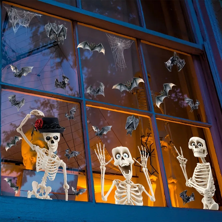 A window display featuring Halloween skull and bat stickers on glass panels.