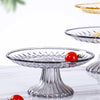 Clear acrylic serving plates for fruit, desserts, and appetizers with a red tomato