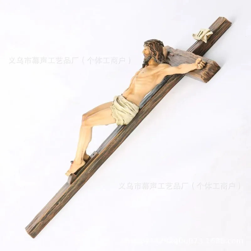 A resin sculpture of Jesus on a wooden cross, depicting the crucifixion.