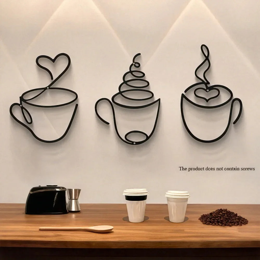 A set of three black iron wall art pieces shaped like coffee cups displayed on a light gray wall.