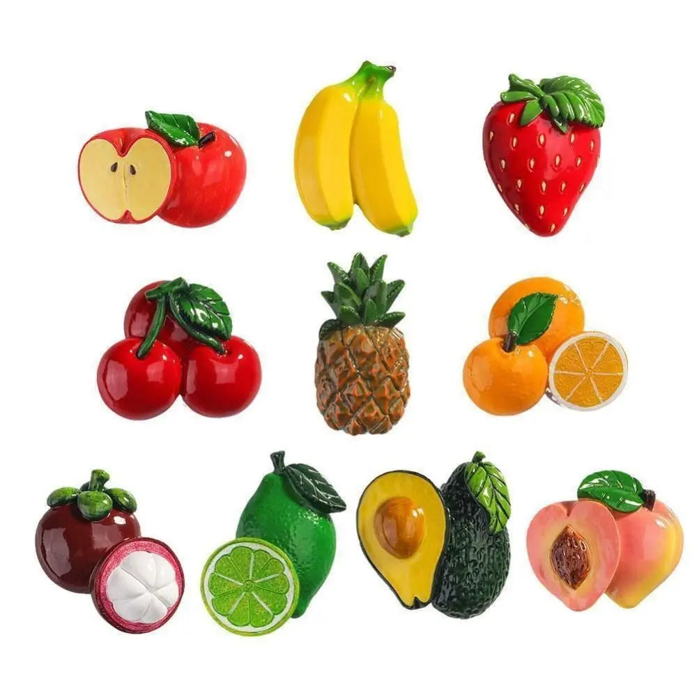 A collection of colorful fruit magnets including a yellow banana, red apple, green strawberry, and orange.