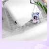 A white wire mesh organizer tray holding a ring binder for trading cards and photos.
