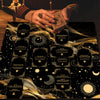 A hand places a tarot altar cloth with gold accents onto a dark surface.