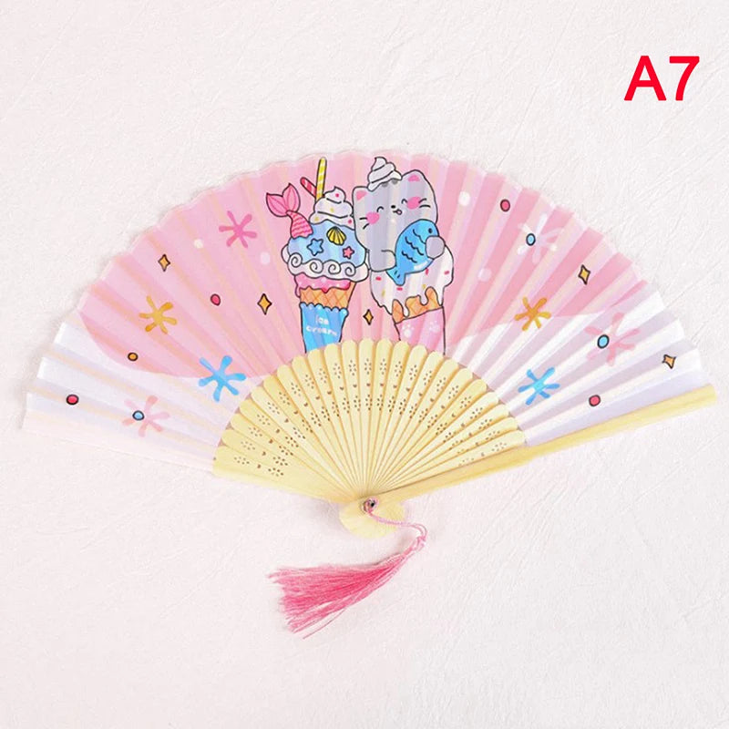 A pink and white folding hand fan decorated with cute ice cream characters for weddings and dance