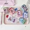 A collection of photo keychains featuring cartoon milk bottle designs in various colors and packaging.
