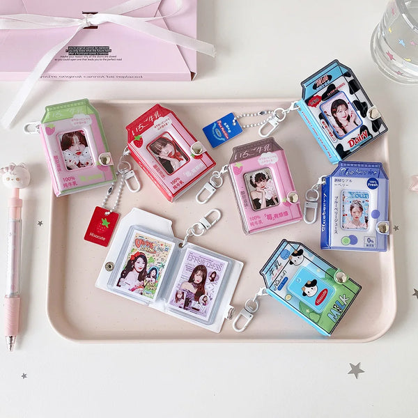 A collection of photo keychains featuring cartoon milk bottle designs in various colors and packaging.