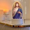 Illuminated Jesus Christ night light featuring a sculpted figure with a beard and long hair set in an oval frame