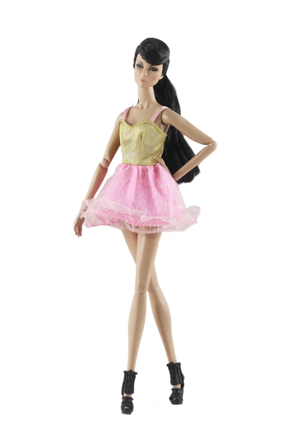 A female doll wearing a gold bodice and pink tulle skirt, standing against a white background.