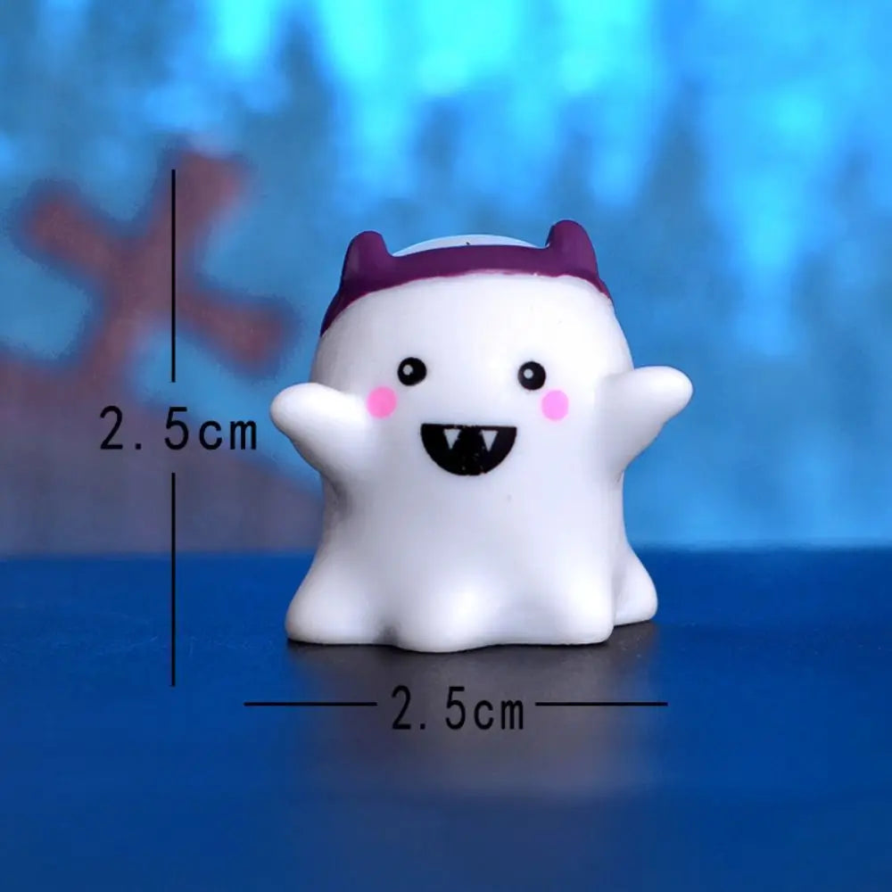 A white resin craft miniature ghost with purple ears and a black mouth, shown against a blue background.