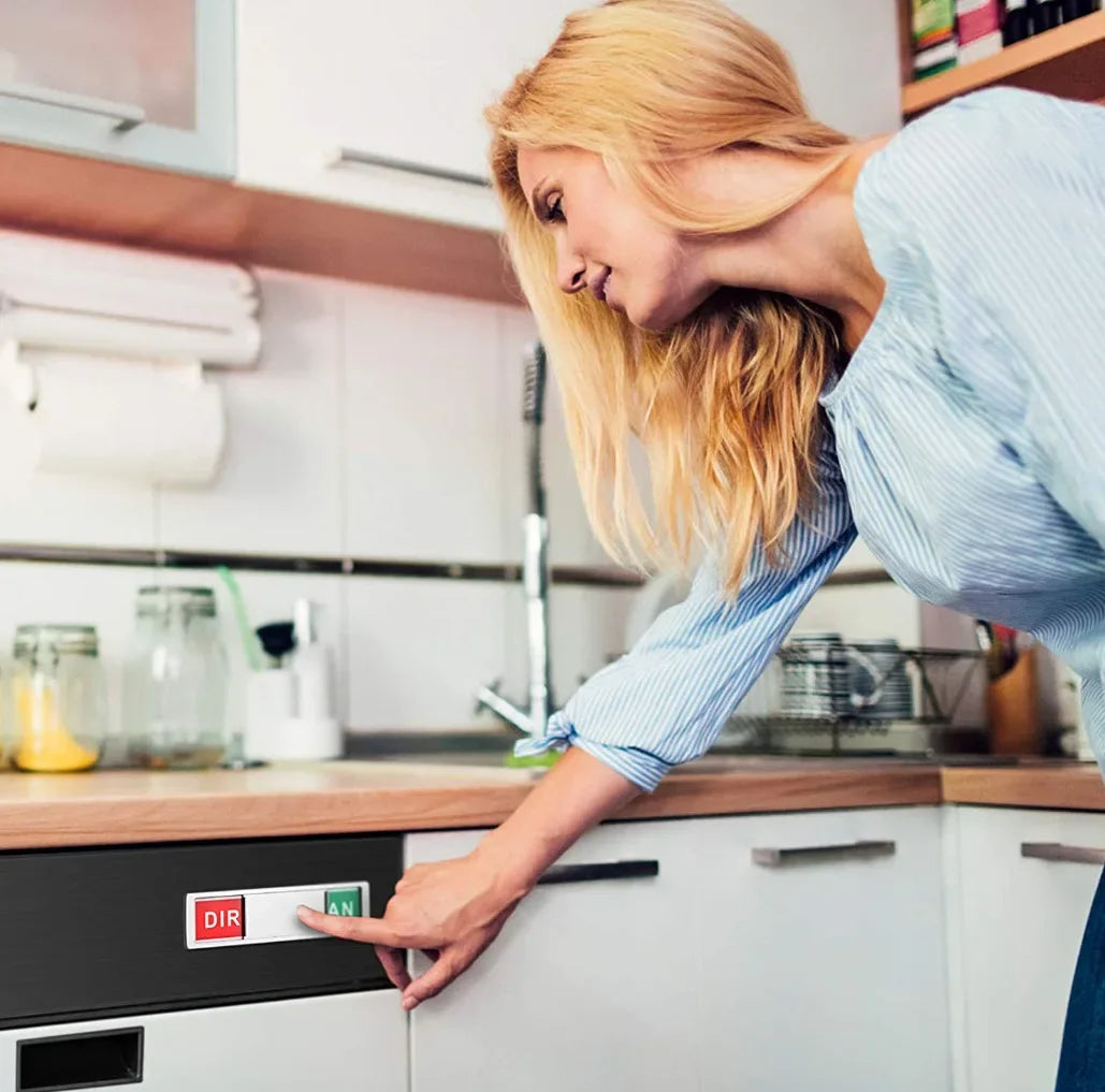 A woman's hand points to a DIRAN magnet sign on the door of a dishwasher.