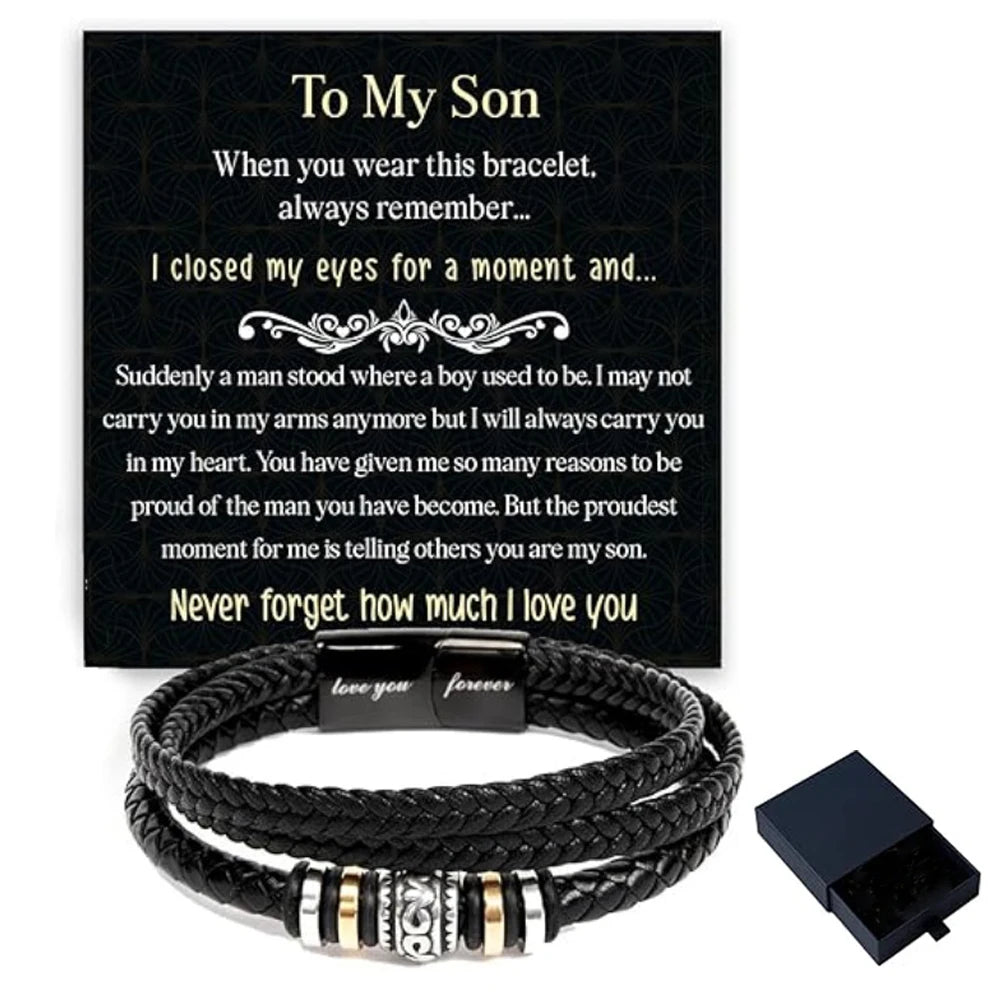 Black braided leather cuff bracelet with a silver clasp and a engraved message on a dark background.