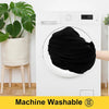 A black fabric is being washed in a white front-loading washing machine.