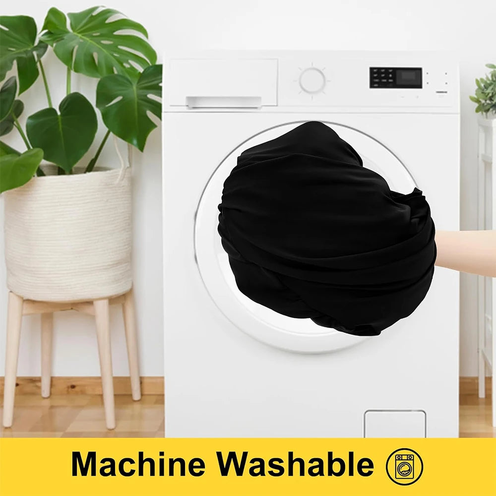 A black fabric is being washed in a white front-loading washing machine.